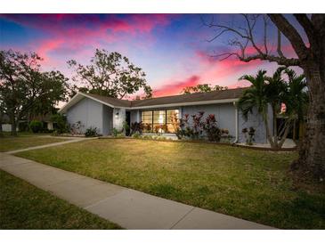 Beautiful home exterior at dusk with landscaping and a well-maintained lawn at 3006 Mockingbird Ct, Clearwater, FL 33762