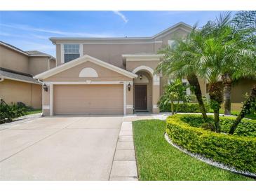 Two-story house with a two-car garage and landscaped front yard at 3795 Morgons Castle Ct, Land O Lakes, FL 34638