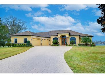 Beautiful one-story home with a three-car garage and paver driveway at 10929 Brooksnest Ct, Lithia, FL 33547