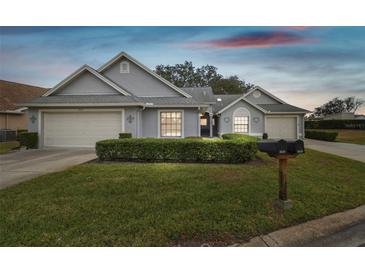 Gray house with two car garage and well-manicured lawn at 3624 Muirfield Ct, New Port Richey, FL 34655