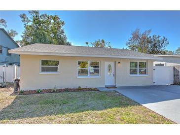 Newly renovated home with a landscaped lawn and driveway at 6706 50Th N Ave, St Petersburg, FL 33709