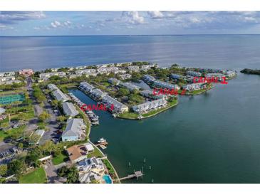 Aerial view of waterfront community with three canals, boat docks, and tennis courts at 0 Starfish Se Dr # 33Ss, St Petersburg, FL 33705