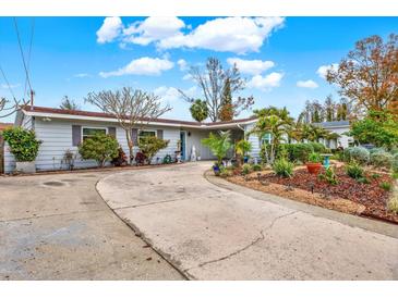 Attractive home exterior with a large driveway and lush landscaping at 3401 W Paris St, Tampa, FL 33614