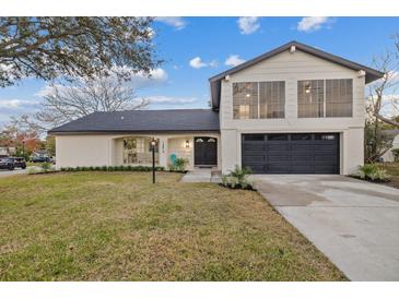 Stunning two-story home boasts a modern exterior, updated landscaping, and a large driveway at 12413 Gunstock Ln, Hudson, FL 34667