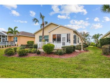 Landscaped backyard with screened porch and white fence at 1933 Sterling Glen Ct, Sun City Center, FL 33573