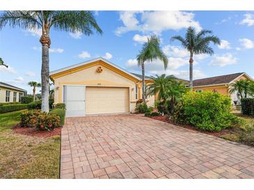 House exterior with a two car garage and landscaping at 1933 Sterling Glen Ct, Sun City Center, FL 33573