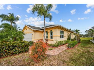 Well-maintained villa with attractive landscaping and brick walkway at 1933 Sterling Glen Ct, Sun City Center, FL 33573