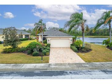 Single-story home with a paved driveway and landscaped lawn at 1950 Sterling Glen Ct, Sun City Center, FL 33573