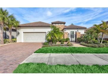 Single-story home with tile roof, stone accents, and landscaped yard at 20105 Umbria Hill Dr, Tampa, FL 33647