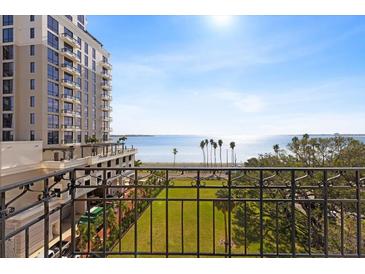 Stunning balcony view overlooking the bay, lush green space, and cityscape at 2109 Bayshore Blvd # 602, Tampa, FL 33606