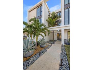 Landscaped walkway leading to the front entrance, featuring lush tropical plants at 2707 N Woodrow Ave # 3, Tampa, FL 33602