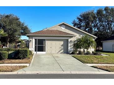 Single-story house with attached garage, landscaping, and a paved driveway at 276 Rochester St, Spring Hill, FL 34609