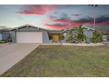 Charming mid-century home with landscaped yard and attached garage at 3435 Roxbury Dr, Holiday, FL 34691