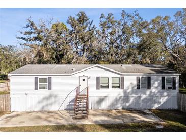 White single-wide manufactured home with gray shutters and metal stairs at 3752 Elfers Pkwy, New Port Richey, FL 34655