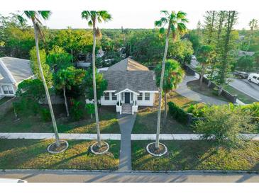 House with a walkway, surrounded by lush tropical landscaping and palm trees at 4056 18Th S Ave, St Petersburg, FL 33711