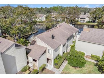 Aerial view of condo building showcasing its location and surrounding landscape at 4154 Pinelake Ln # 101, Tampa, FL 33618