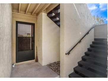 Inviting entryway with private staircase and exterior door at 4154 Pinelake Ln # 101, Tampa, FL 33618