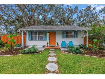 Charming bungalow with a landscaped front yard, orange fence, and stone pathway at 5402 8Th S Ave, Gulfport, FL 33707