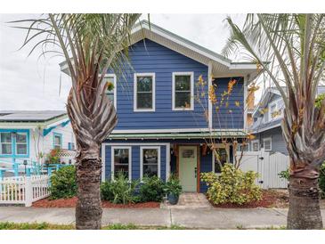 Charming two-story blue home with white accents and palm trees at 605 7Th N St, St Petersburg, FL 33701