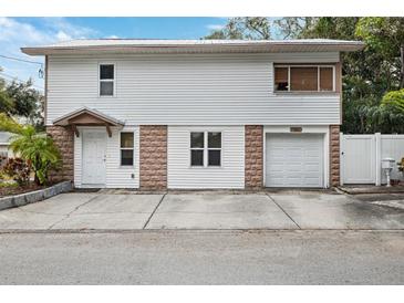 Two-story house with attached garage and small front yard at 832 13Th N Ave, St Petersburg, FL 33701