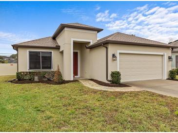 One-story house with a two-car garage and well-manicured lawn at 1575 N River Cir, Tarpon Springs, FL 34689