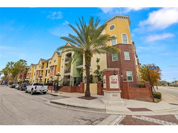 Brick building exterior with palm trees and street view at 1910 E Palm Ave # 8214, Tampa, FL 33605