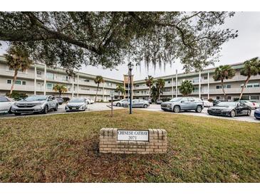 Building exterior, ample parking, lush landscaping at 2071 Australia W Way # 17, Clearwater, FL 33763