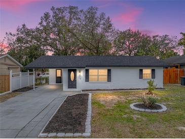 Charming ranch-style home with freshly painted exterior and landscaped yard at 2104 W Okaloosa Ave, Tampa, FL 33604