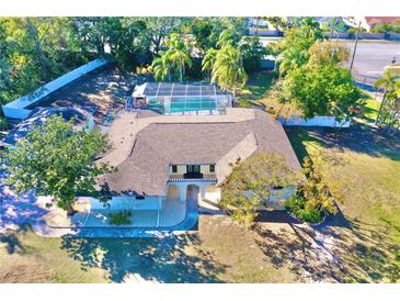 Single-story home with pool and large backyard at 2142 Hickory Gate W Dr, Dunedin, FL 34698