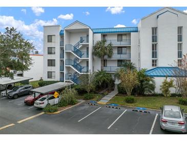 Exterior view of a condo building with parking and landscaping at 2424 W Tampa Bay Blvd # L102, Tampa, FL 33607