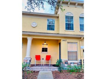 Inviting exterior of a two-story townhome with a small front porch and landscaping at 3417 Dragon View Ct # 3417, Valrico, FL 33594