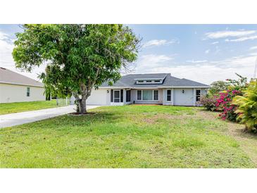 Single-story home with gray roof, landscaping, and driveway at 364 San Ambrosio St, Punta Gorda, FL 33983