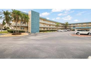 Building exterior showcasing ample parking and landscaping at 5750 80Th St N # B106, St Petersburg, FL 33709