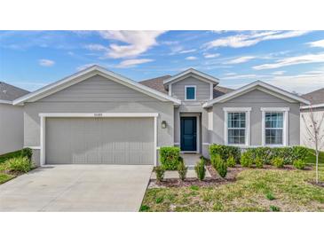 Curb appeal abounds in this charming one-story home, featuring a two-car garage and well-manicured lawn at 10399 Gliding Eagle Way, Land O Lakes, FL 34638