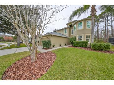 Two-story house with a landscaped yard and attached garage at 12127 Luftburrow Ln, Hudson, FL 34669