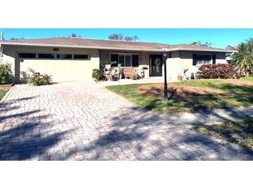 Ranch style home with brick paver driveway and mature landscaping at 3182 65Th N St, St Petersburg, FL 33710