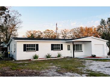 Newly renovated single-story home featuring a white exterior, black shutters, and a landscaped front yard at 5109 Gateway Dr, Tampa, FL 33615