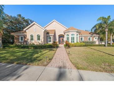 Beautiful two-story home with a brick facade and lush landscaping at 530 Ponce De Leon Blvd, Belleair, FL 33756