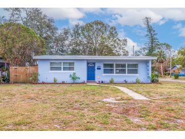 Charming light blue house with a well-maintained lawn and walkway at 674 61St S Ave, St Petersburg, FL 33705