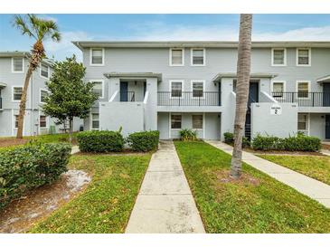 Building exterior showcasing a well-maintained building with landscaping at 7117 E Bank Dr # 2, Tampa, FL 33617