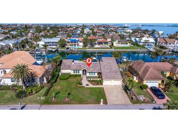 Bird's eye view of waterfront property showcasing canal access and neighborhood at 127 Sands Point Dr, St Petersburg, FL 33715