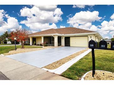 Single-story home with attached garage and landscaped yard at 1613 Faxton Dr, Sun City Center, FL 33573