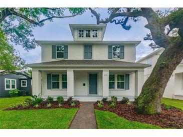 Two-story house with gray shutters and a landscaped front yard at 1742 W Saint Louis St, Tampa, FL 33607
