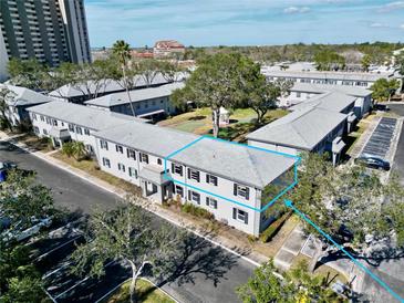 Aerial view of an apartment building complex with ample parking and landscaping at 6915 Avenue Des Palais # 2B, South Pasadena, FL 33707