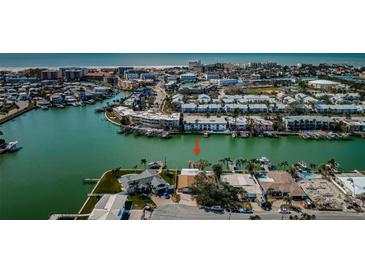 Aerial view of waterfront home with private dock and boat slips at 11650 4Th E St, Treasure Island, FL 33706