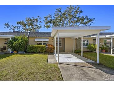 Cute Florida home with carport and well-manicured lawn at 204 Sky Loch W Dr, Dunedin, FL 34698