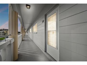 Well-lit hallway with access to unit 104 at 2460 Franciscan Dr # 20, Clearwater, FL 33763