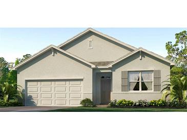 One-story house with light gray siding, shutters, and a two-car garage at 32763 Osprey Peak Way, San Antonio, FL 33576