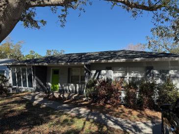 Updated one-story home with green door and landscaped yard at 4619 W Bay Villa Ave, Tampa, FL 33611