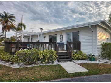 White single story home with deck and landscaped yard at 236 Carol Dr # 236, Seminole, FL 33772